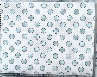 May include: A white background with a repeating pattern of blue and white gingham circles outlined in black.