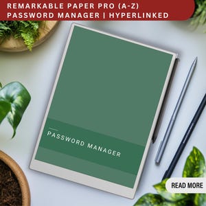 May include: A green digital notepad with the text "PASSWORD MANAGER" on the screen. The notepad is on a white surface with a silver stylus and a black stylus next to it. The text "READ MORE" is visible in the lower right corner of the image.