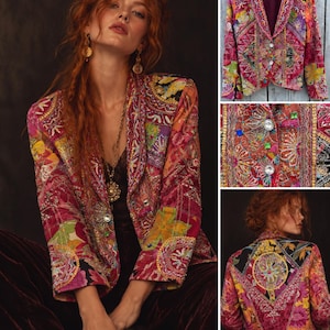 May include: A long-sleeve blazer featuring a vibrant patchwork of floral and geometric patterns in shades of pink, red, orange, and yellow. The garment is heavily embellished with intricate beadwork, sequins, and metallic embroidery, including two clear crystal buttons on the front.
