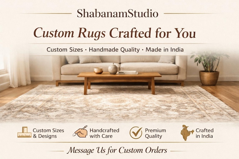 May include: An interior shot featuring a beige rug with a patterned design, beneath a wooden coffee table and a beige sofa. The text reads "Custom Rugs Crafted for You" and "Custom Sizes, Handmade Quality, Made in India."