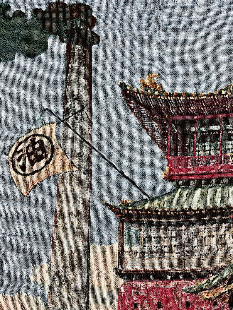 May include: A tapestry depicting a traditional Chinese building with a red roof and a tall chimney with smoke coming out of it. The building has a white flag with black Chinese characters on it. The tapestry is made of a woven fabric with a textured surface.