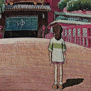 May include: A tapestry depicting a young person standing in front of a red and green building with a sign that reads "ゆめ". The building has many windows and a roof with a green overhang. The person is wearing a white shirt with a green stripe and a green skirt.