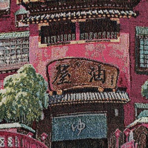 May include: A tapestry depicting a traditional Japanese building with a red roof and intricate details. The building has a sign that reads "森永", which is the Japanese name for Morinaga, a popular confectionery company. The tapestry features a variety of colours, including red, green, blue, and brown.