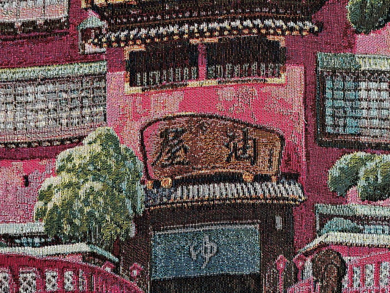 May include: A tapestry depicting a traditional Japanese building with a red roof and intricate details. The building has a sign that reads "森永", which is the Japanese name for Morinaga, a popular confectionery company. The tapestry features a variety of colours, including red, green, blue, and brown.