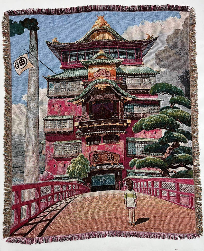 May include: A tapestry depicting a multi-storey building with a red and green exterior, a bridge leading to the building, and a small figure standing on the bridge. The building has a traditional Japanese architectural style with intricate details and a sign that reads "油" in Japanese.