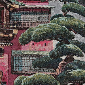 May include: A tapestry depicting a red and pink building with a green roof and several windows. The building is surrounded by vibrant green trees with brown branches.