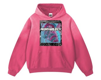 May include: A vibrant pink hoodie with a front pocket and a hood. The hoodie features a graphic on the front with the text "PRETTY HATE MECH" in white, set against a blue and black design. The hoodie is made of a soft material.