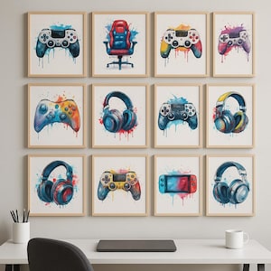May include: A set of framed watercolour art prints with gaming themes. The prints depict colourful game controllers, gaming headsets, and a gaming chair, all with a vibrant, artistic flair. The artwork is set against a white background.