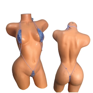 May include: A light blue lingerie set with a halter top and a thong bottom. The set is made of a stretchy, silky material and has a delicate lace trim.