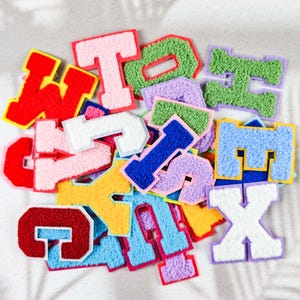 May include: A set of three ceramic mugs with a speckled, matte finish. The mugs are in shades of cream, light gray, and dark gray. Each mug has a simple, minimalist design, perfect for coffee or tea.