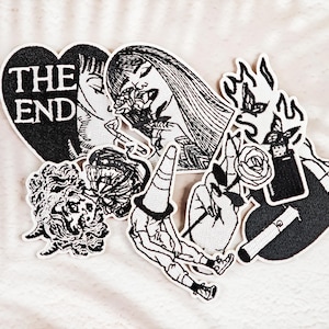 May include: A set of three ceramic mugs with a speckled, matte finish. The mugs are in shades of cream, light gray, and dark gray. Each mug has a simple, minimalist design, perfect for coffee or tea.