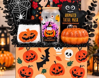 May include: A Halloween gift box featuring a pumpkin and skull pattern, containing a coffin-shaped box, a floral pouch, fuzzy pumpkin socks, a frosted glass tumbler with a ghost graphic, a black cat facial mask, and an orange pumpkin-shaped jar.