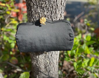 Black silk clutch with brass flower clasp