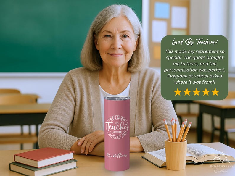 May include: A pink insulated tumbler with the text "Retired Teacher Class of 2023" and "Mr. Williams" in white. The tumbler is held by a woman in a classroom setting. A green sign says "Loved By Teachers!"