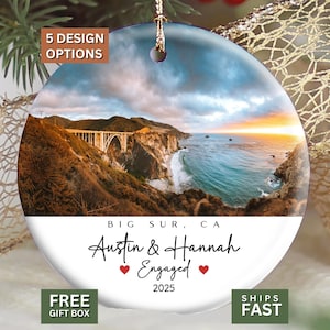 May include: A round ceramic ornament featuring a scenic photograph of the Bixby Creek Bridge in Big Sur, California. The text reads BIG SUR, CA, Austin & Hannah Engaged, and 2025, accented by two small red hearts. It hangs from a gold string.