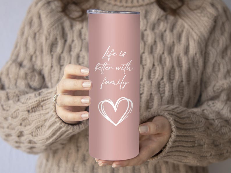 May include: A pink stainless steel tumbler with a white heart and the text "Life is better with family".