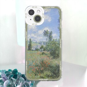 May include: A phone case featuring a landscape painting by Claude Monet. The case has a clear border with the text "CLAUDE MONET" and "ART LIFE" printed on it. The artwork depicts a field of flowers and trees under a blue sky.