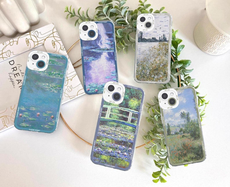 May include: A collection of clear phone cases featuring famous impressionist paintings by Claude Monet. Each case displays a different artwork, including water lilies, landscapes, and bridges, with the text "ART LIFE" and "CLAUDE MONET" printed on the case.
