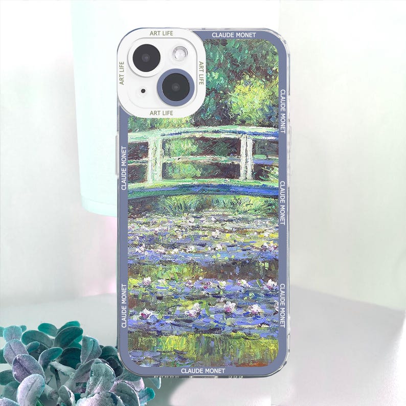 May include: A phone case featuring a painting by Claude Monet. The case displays a water lily pond scene with a bridge, in shades of green, blue, and purple. The text "ART LIFE" and "CLAUDE MONET" are printed on the case.
