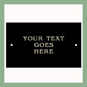 May include: Black plaque with gold lettering that reads "YOUR TEXT GOES HERE".