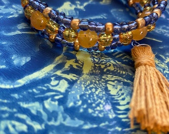 warm twilight glow wrap bracelet with ochre and dusk colors, includes a tassel, and glass beads