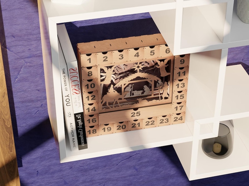Light wooden advent calendar displayed on a white shelving unit next to books with visible text spines.