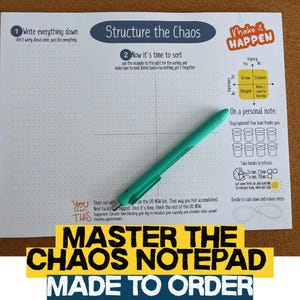 May include: A notepad with a grid layout and the text "Structure the Chaos" and "Master the Chaos Notepad Made to Order." A teal pen rests on the notepad. The notepad includes sections for task prioritization and personal notes.