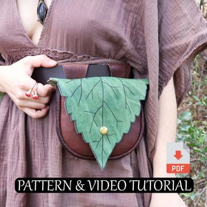May include: A brown leather pouch with a green leaf-shaped flap and a gold button closure. The pouch is worn on a belt. The text "PATTERN & VIDEO TUTORIAL" is displayed on the image.