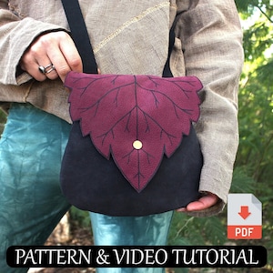 May include: A black and burgundy leaf-shaped crossbody bag with a gold button. The bag is worn by a person in a forest setting.  PATTERN & VIDEO TUTORIAL. PDF.