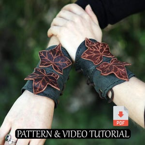 May include: Dark green leather wrist cuffs with brown leaf accents. The cuffs are laced and feature a decorative leaf design. The image includes the text "PATTERN & VIDEO TUTORIAL".