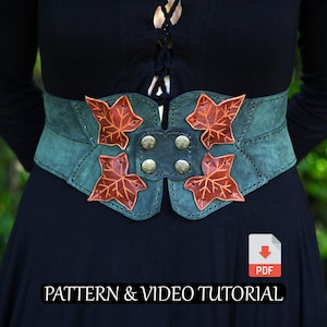 May include: A teal suede belt with four copper-colored leaf accents. The belt is fastened with four brass-colored buttons. The text "PATTERN & VIDEO TUTORIAL" is visible at the bottom of the image.