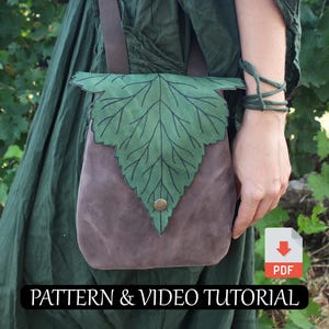 May include: A brown suede shoulder bag with a green leaf-shaped flap and a button closure. The bag has a brown strap and the text "PATTERN & VIDEO TUTORIAL" at the bottom.