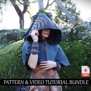 May include: A hooded cape and matching wrist cuffs in a dark blue suede-like material, adorned with brown leaf-like accents. The cape is worn over a patterned dress. The image includes the text "PATTERN & VIDEO TUTORIAL BUNDLE".
