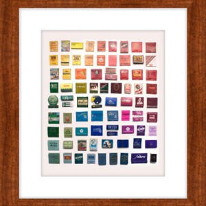 May include: A collection of vintage matchboxes arranged in a rainbow pattern. The matchboxes are from various brands and feature different designs and colors.