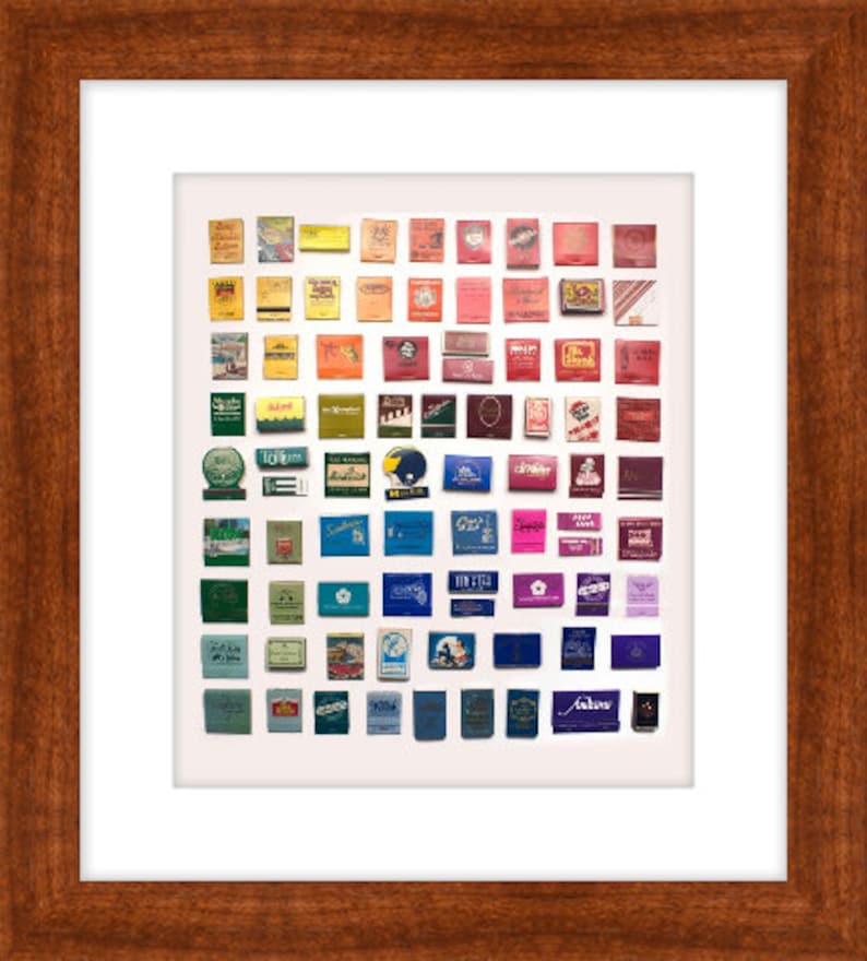 May include: A collection of vintage matchboxes arranged in a rainbow pattern. The matchboxes are from various brands and feature different designs and colors.