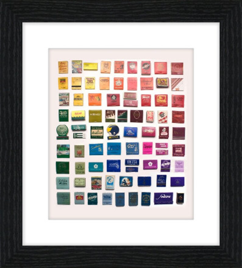 May include: A collection of vintage matchboxes arranged in a rainbow pattern. The matchboxes are from various brands and feature different designs and colors.