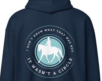May include: Navy blue hooded sweatshirt with a white circle graphic. The graphic features a rider on a horse and the text "I don't know what that was but it wasn't a circle."