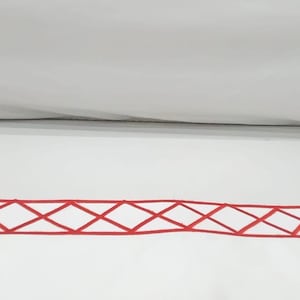 May include: White bedding with a red diamond pattern border.