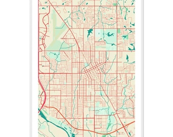 May include: A framed map print of Norman, Oklahoma. The map features a network of red roads and streets over a beige background, with green areas representing parks and water bodies. The city name is printed in black at the bottom.