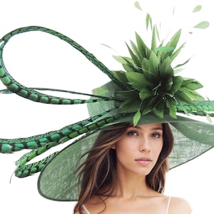 May include: A large green hat with a wide brim and a green feather embellishment. The hat is made of a textured fabric and has a large green flower on top.