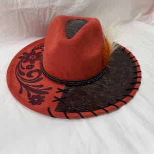 Custom hand burned rust orange wide brim hat, faux leather with black leather lacing and  flower design burned on brim.