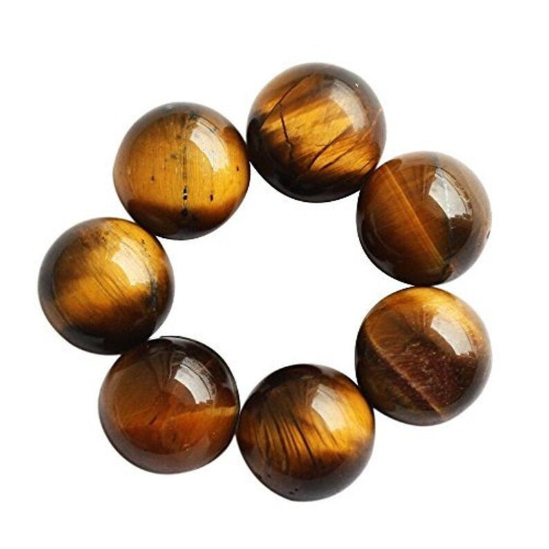 May include: Seven polished tiger's eye gemstone spheres arranged in a circular pattern. The spheres are a mix of golden brown and dark brown with natural striations and a glossy finish. The gemstones are round and smooth.
