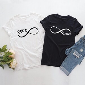 May include: Two t-shirts, one white and one black, with the text "Best" and "Friends" on each, connected by an infinity symbol.