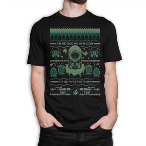 Könnte beinhalten: Schwarzes T-Shirt mit einem pixelartigen Design in Grün und Weiß, das eine Kreatur aus dem Film Alien zeigt. Das Design enthält den Text "Im Weltraum kann dich niemand schreien hören".
