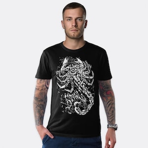 May include: Black t-shirt featuring a detailed white graphic of a scorpion. The scorpion design is intricate, with a textured appearance. The shirt is a classic crew neck style, suitable for casual wear. The graphic includes the text "HMNR".