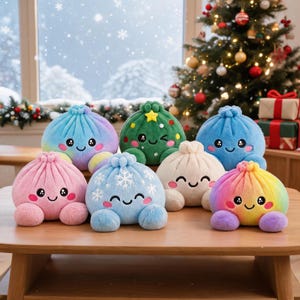 May include: A collection of seven plush dumpling toys with embroidered faces. The group includes a pink one, a blue one with white snowflakes, a cream one, a green one with a yellow star, a solid blue one, and two rainbow-coloured plushies.