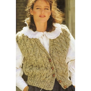 May include: A knitted vest in shades of tan and green with wooden buttons. The vest has a cable knit design and is worn over a white blouse with a ruffled collar. The overall style is vintage and classic.
