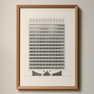 May include: A framed architectural print of a high-rise building, rendered in black and white. The print features a detailed facade with many windows. The artwork is presented in a light brown wooden frame, mounted on a white background.
