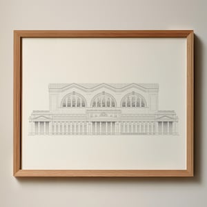 May include: Architectural drawing of a building with arched windows and columns, framed in a light brown wooden frame. The drawing is in black and white, showcasing the building's facade.