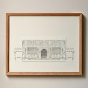 May include: A framed architectural drawing of a building facade. The detailed pencil sketch depicts arched windows, columns, and a central arched doorway. The frame is made of light brown wood.